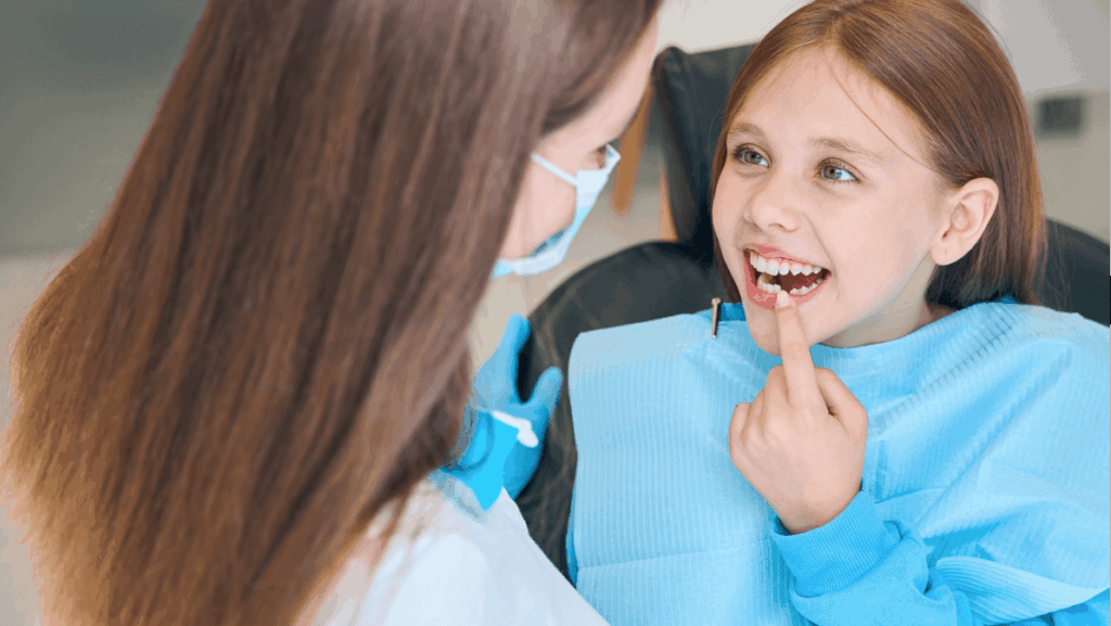 Girl shows her teeth to a woman a dentist