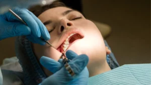 Dental surgeon performs conduction anesthesia with lidocaine using a carpool syringe