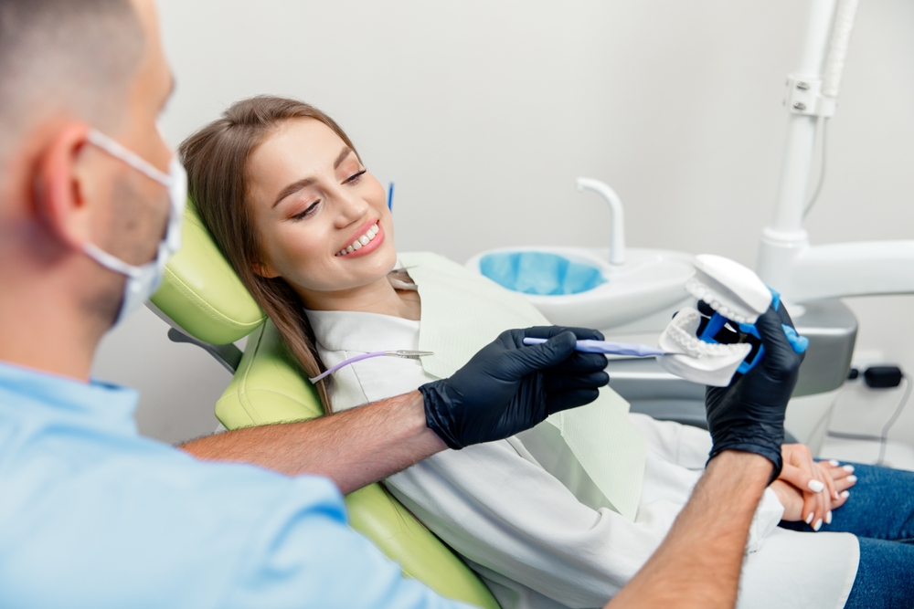 Dentist checking teeth during dental examination to a woman