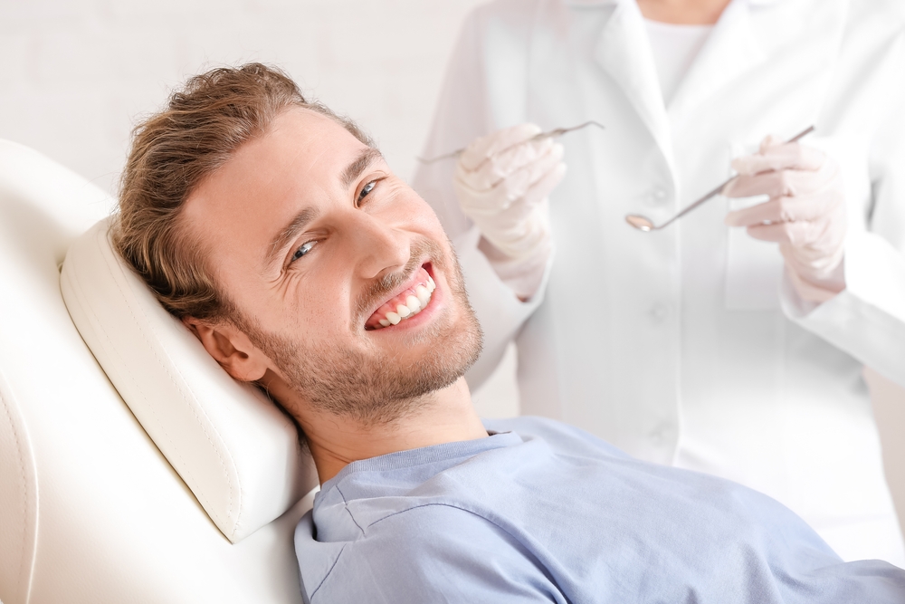 Young man visiting dentist in clinic